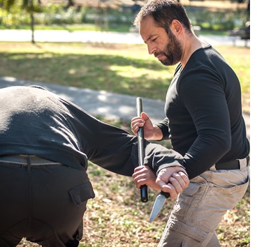 man using stick baton for defense